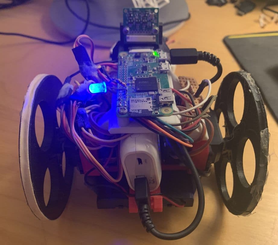 The robot's back view. I used a portable battery pack to power the robot, and batteries to power the motor. An LED light is used to indicate controller connection.