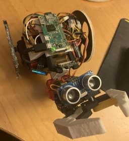 The robot's top view, showing the camera and ultrasonic sensor. The camera was used for object detection and the ultrasonic sensor was used to determine distance to objects.